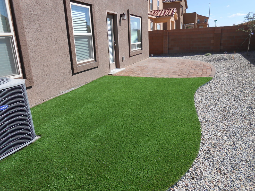 Photo of a mid-sized southwestern full sun backyard gravel landscaping in Other.