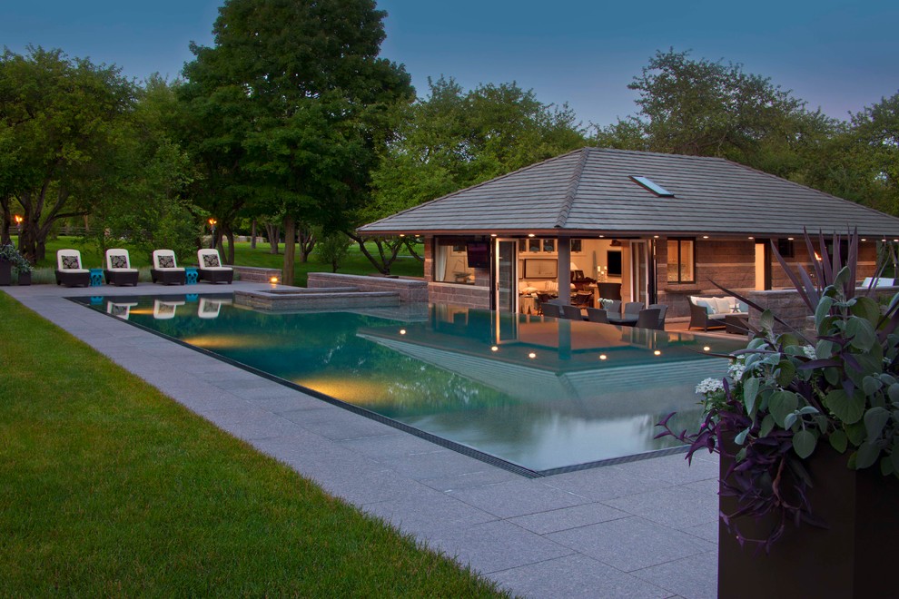 Inspiration for a large transitional hillside water fountain landscape in Detroit with decking.