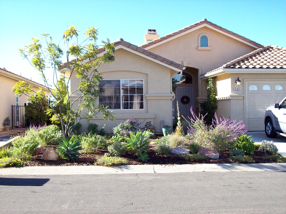 Medium sized traditional front driveway partial sun garden in San Diego with concrete paving.