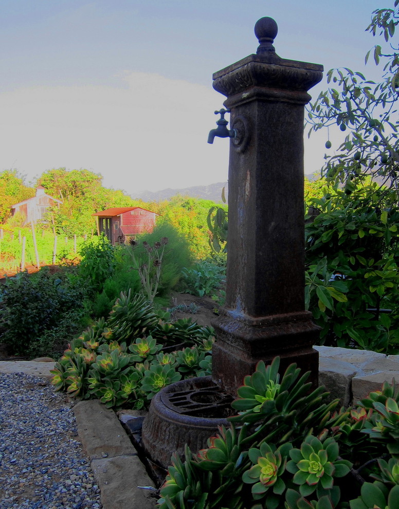 Photo of a small farmhouse partial sun backyard gravel water fountain landscape in Santa Barbara for spring.