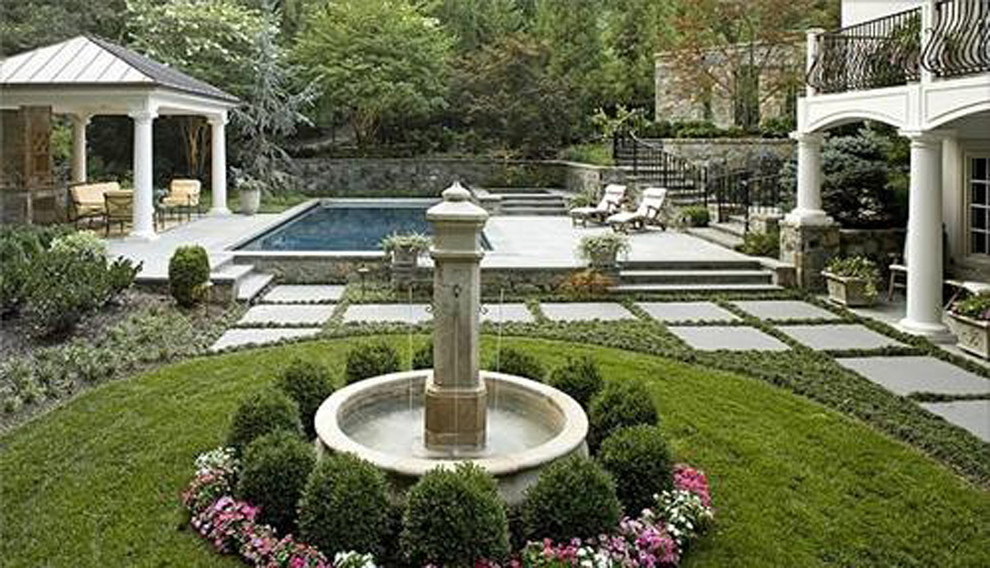 Inspiration for a large mediterranean partial sun backyard stone water fountain landscape in New York.