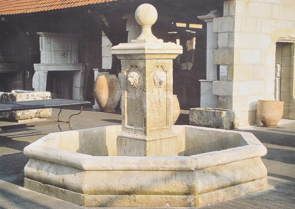 This is an example of a large mediterranean partial sun backyard stone water fountain landscape in New York.