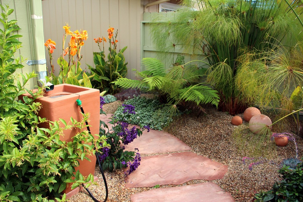 Photo of a mid-sized mediterranean drought-tolerant and partial sun backyard stone water fountain landscape in San Luis Obispo.