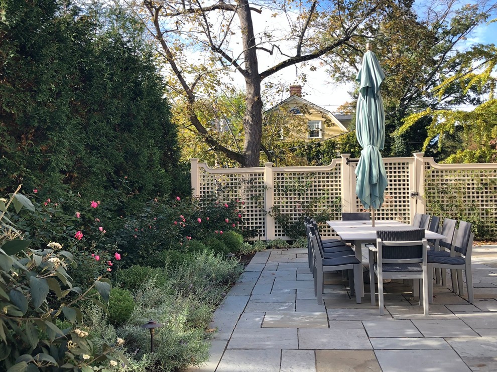Photo of a large traditional garden in Boston with natural stone paving.