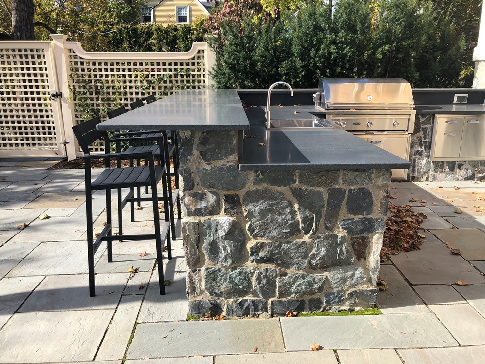 Large traditional patio in Boston with natural stone paving.