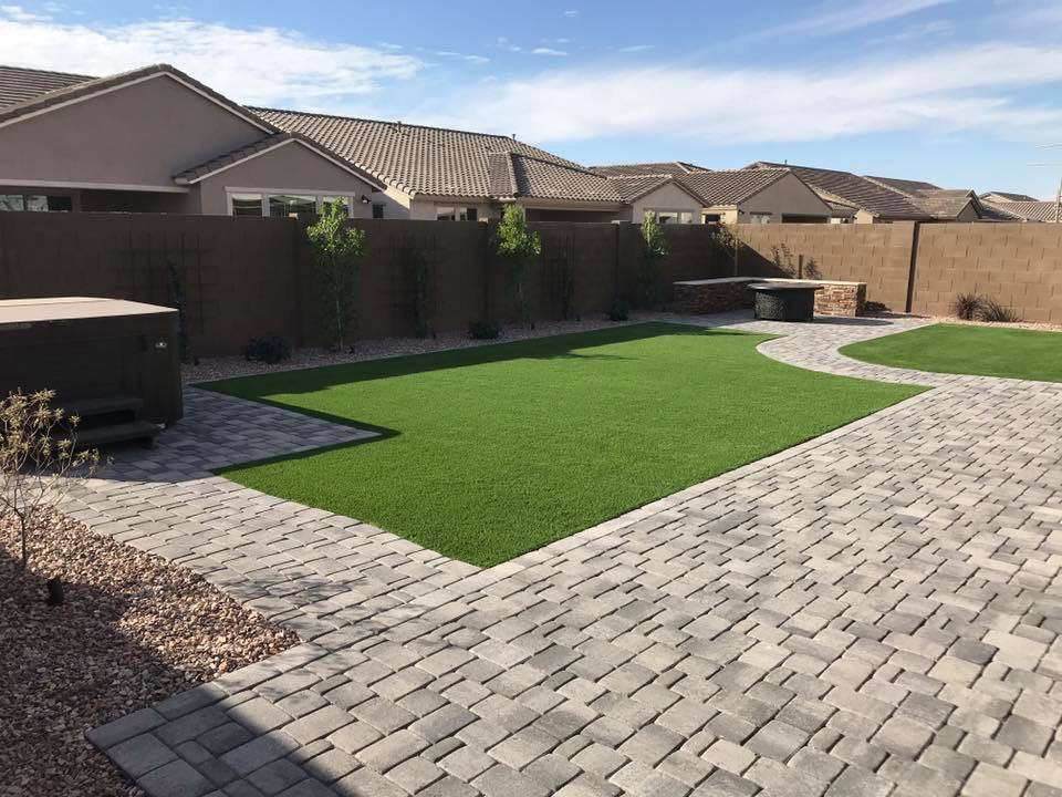 Design ideas for a large contemporary full sun backyard stone and stone fence landscaping in Phoenix.