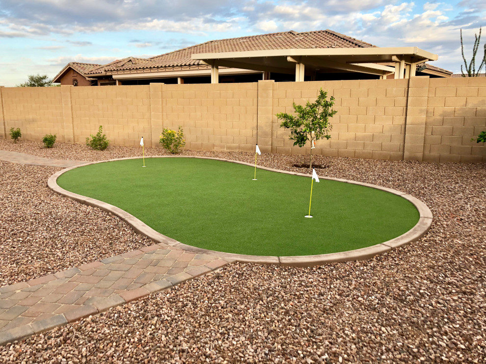 Großer Moderner Garten hinter dem Haus mit direkter Sonneneinstrahlung, Natursteinplatten und Steinzaun in Phoenix