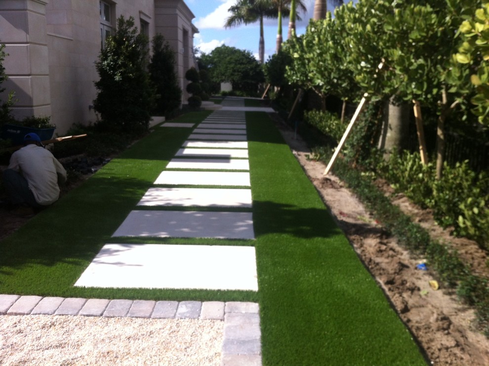 Design ideas for a large traditional back full sun garden in Miami with a garden path and natural stone paving.