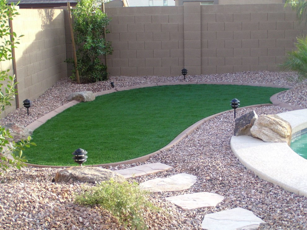 This is an example of a small classic back partial sun garden in Phoenix with an outdoor sport court and gravel.