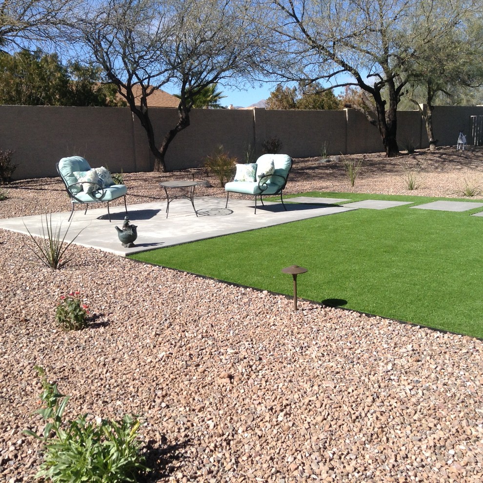 Photo of a mid-sized contemporary drought-tolerant backyard landscaping in Phoenix with decking for spring.