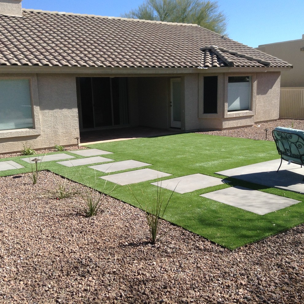 Design ideas for a mid-sized contemporary drought-tolerant backyard landscaping in Phoenix with decking for spring.