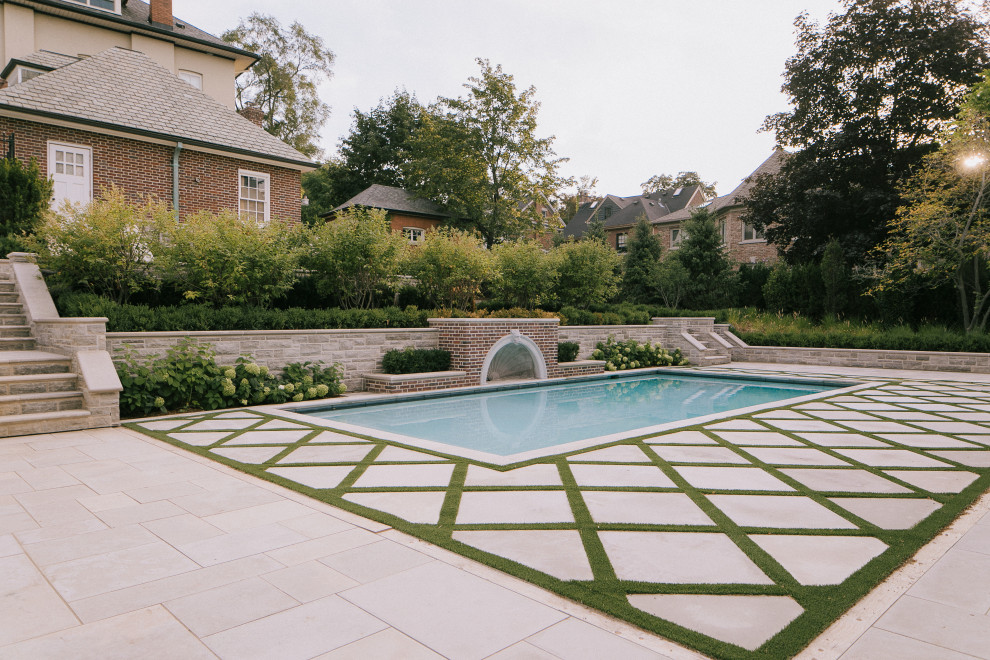 Photo of a large traditional backyard stone landscaping in Toronto.