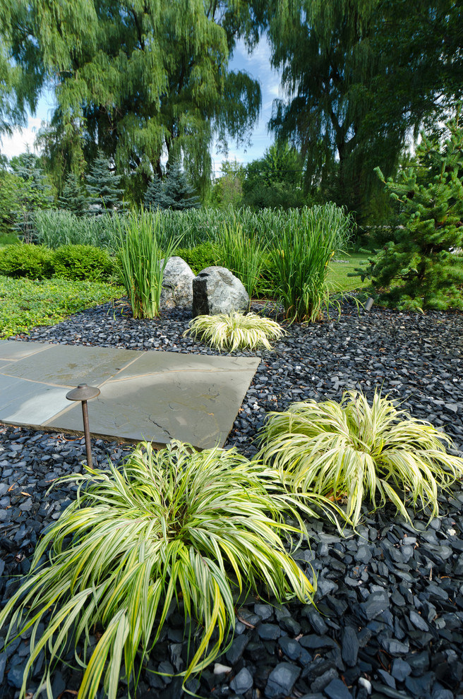 Imagen de jardín contemporáneo de tamaño medio en patio delantero con gravilla