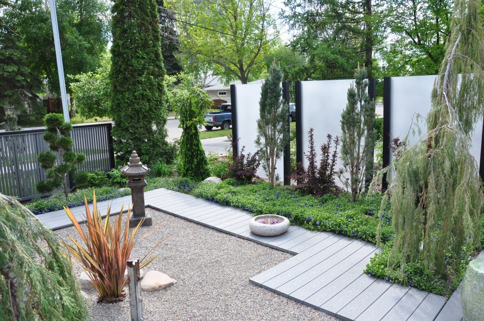 Idee per un giardino formale etnico di medie dimensioni e dietro casa con ghiaia