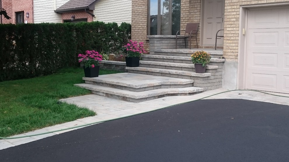 Design ideas for a contemporary front yard concrete paver driveway in Montreal.