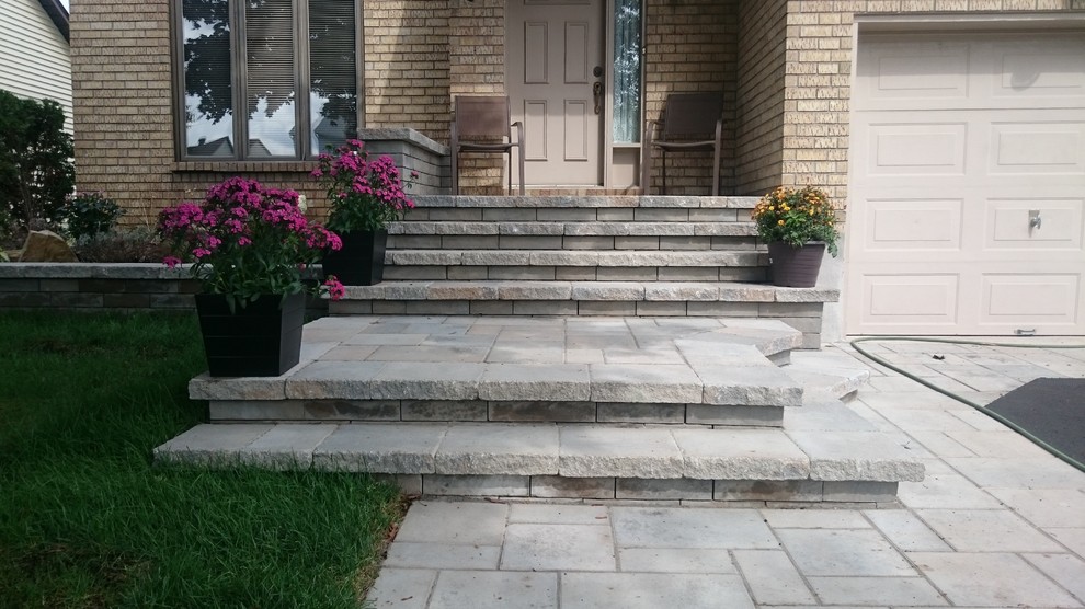 Contemporary front driveway garden in Montreal with concrete paving.