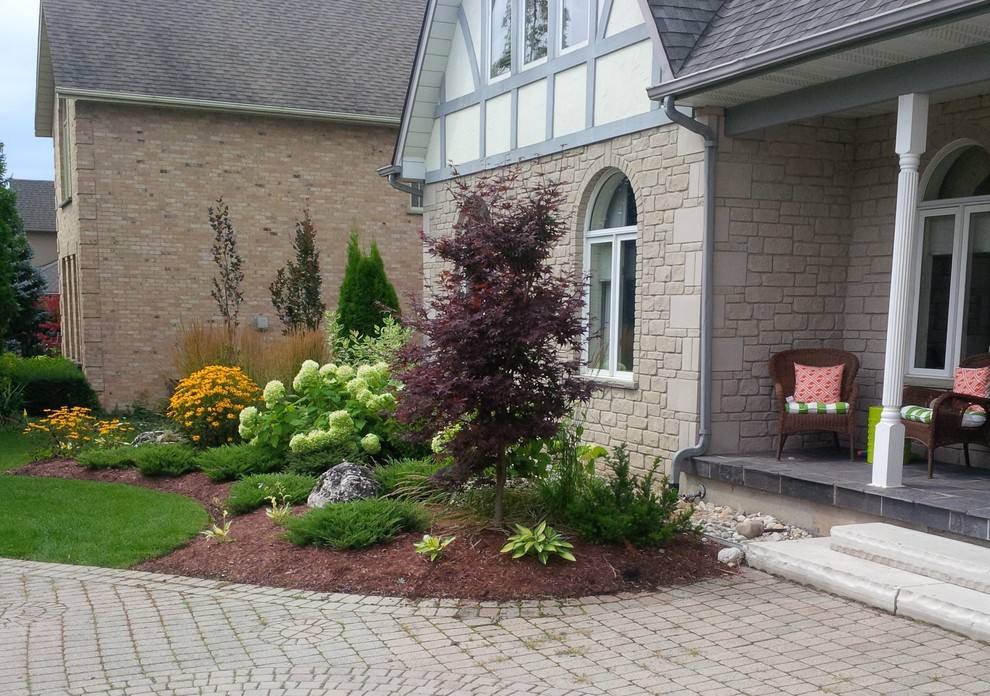 Inspiration for a large contemporary full sun front yard brick driveway in Toronto for summer.