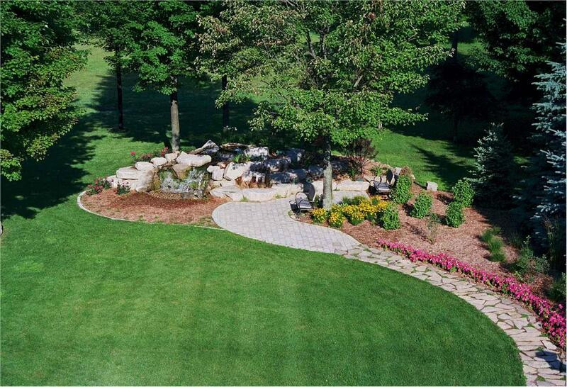 Design ideas for a mid-sized modern full sun backyard brick landscaping in Atlanta for summer.