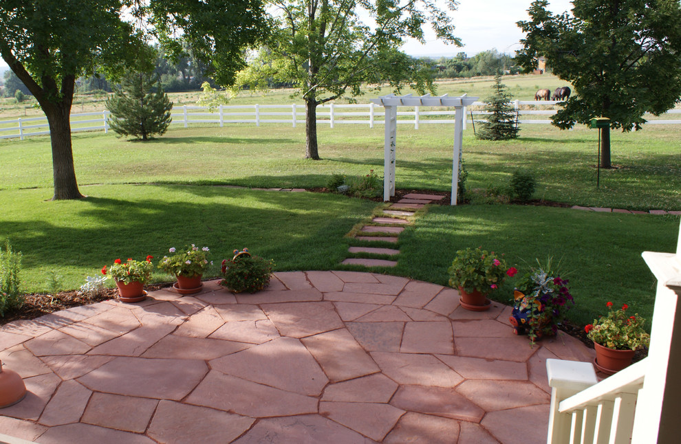 Design ideas for a medium sized traditional back formal partial sun garden for summer in Denver with a garden path and natural stone paving.