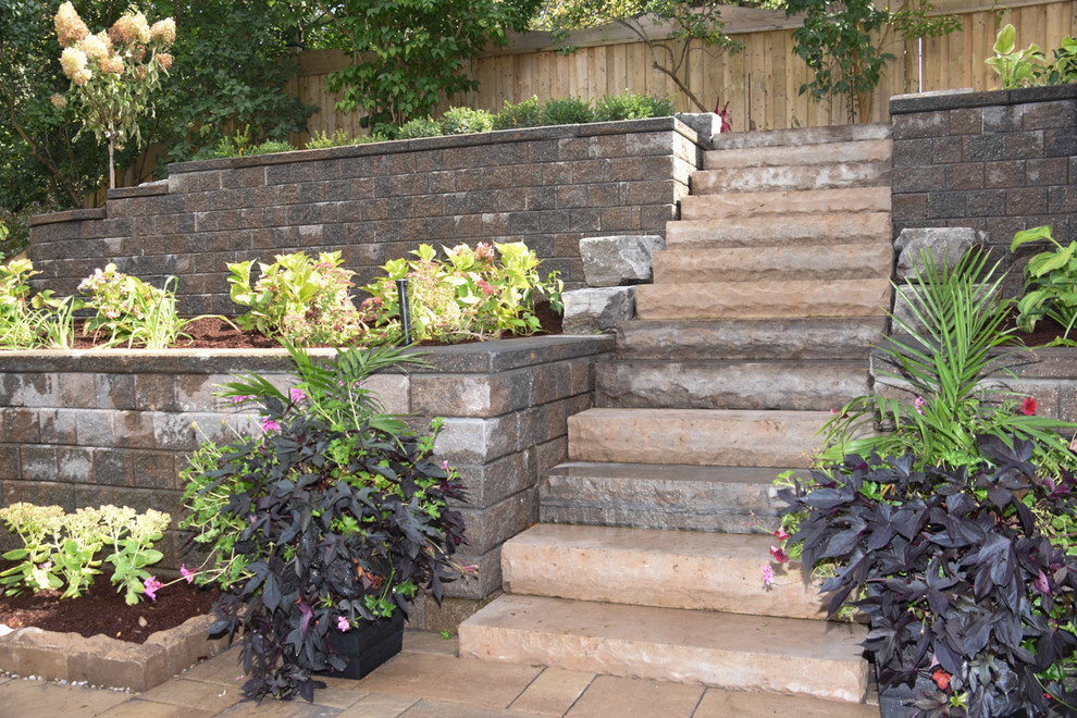 This is an example of a large contemporary back formal full sun garden for summer in Other with a living wall and concrete paving.