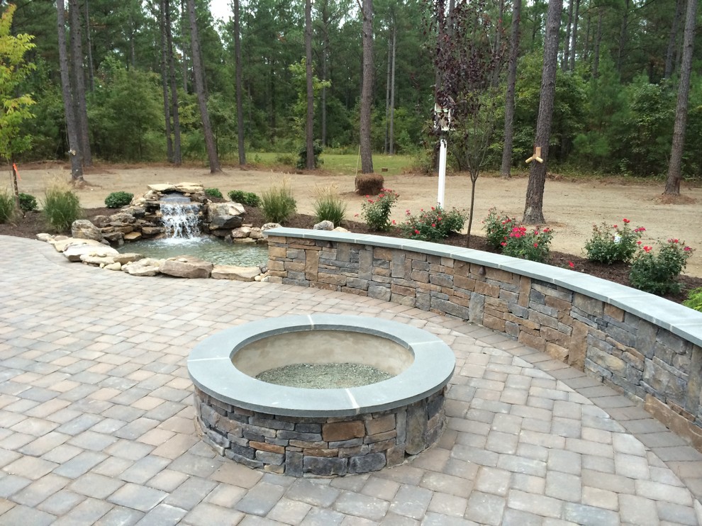 Photo of a large traditional back partial sun garden in Richmond with a fire feature and brick paving.