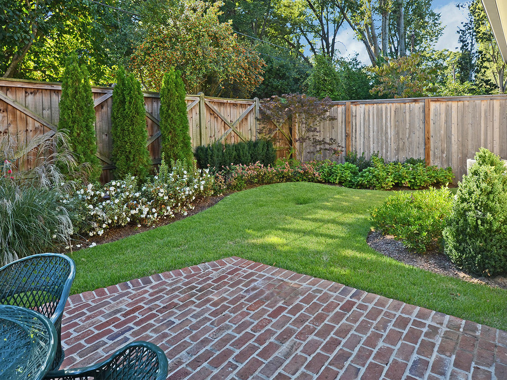 Medium sized classic back full sun garden in Other with brick paving.