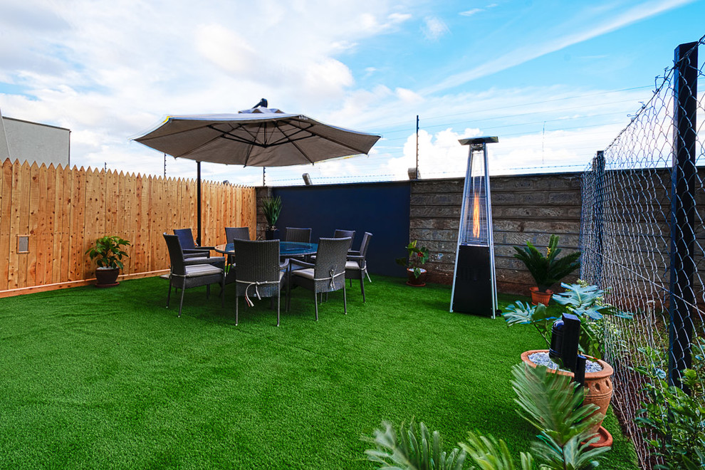 Cette photo montre un jardin arrière tendance de taille moyenne et l'été avec une exposition ensoleillée et une terrasse en bois.