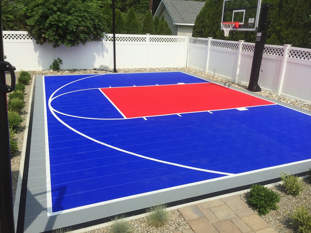 This is an example of a medium sized modern back full sun garden in New York with an outdoor sport court and a climbing frame.