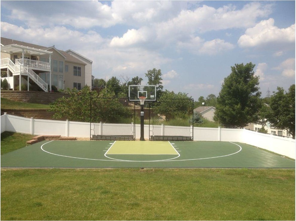 This is an example of a large classic side partial sun garden for summer in St Louis with an outdoor sport court.
