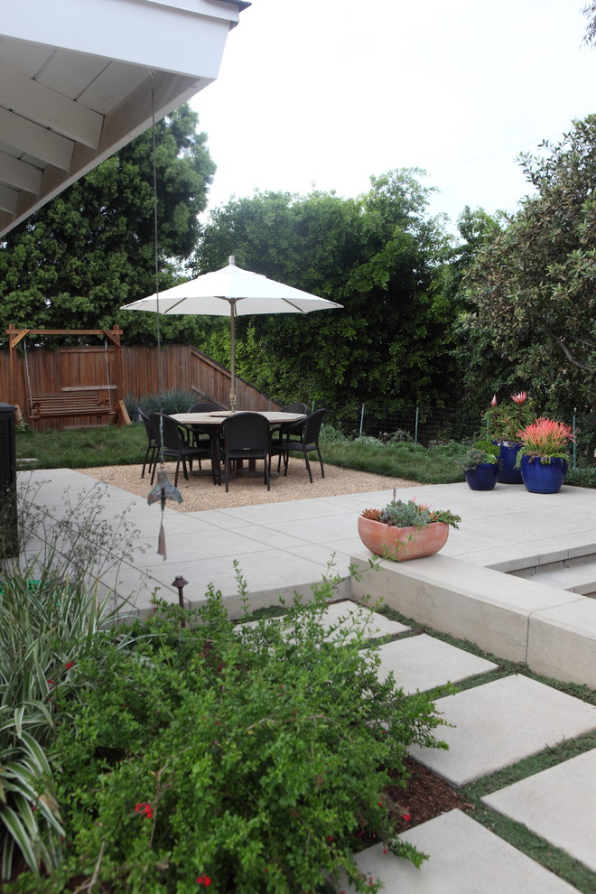 This is an example of a coastal partial sun backyard concrete paver landscaping in Los Angeles for spring.