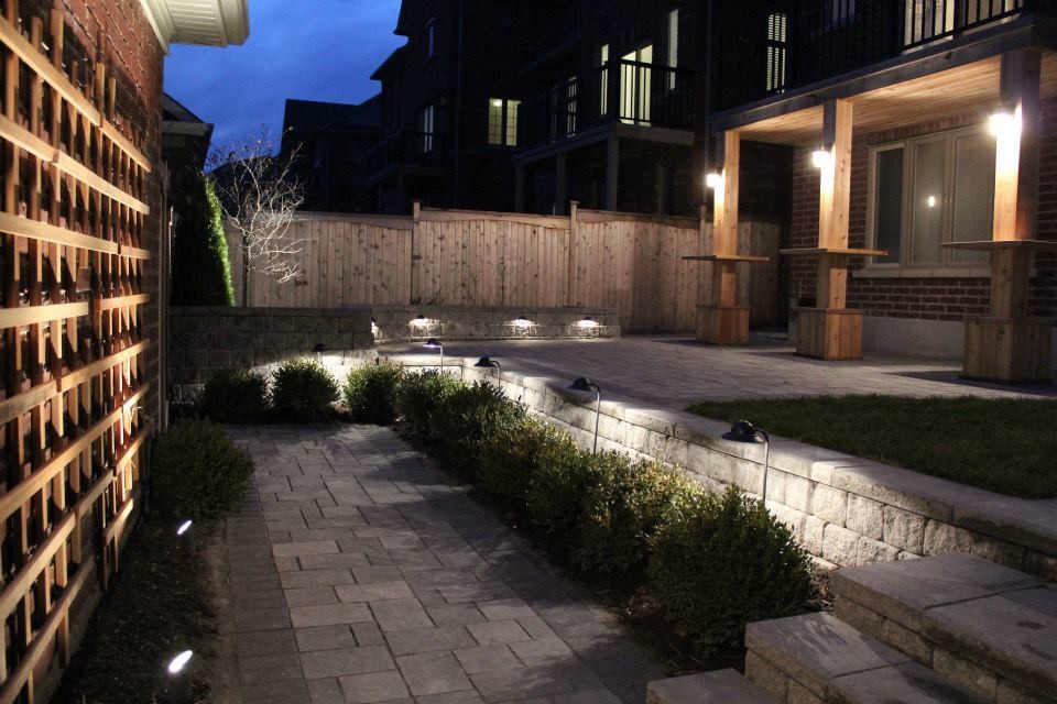 This is an example of a mid-sized contemporary partial sun backyard concrete paver garden path in Toronto for summer.