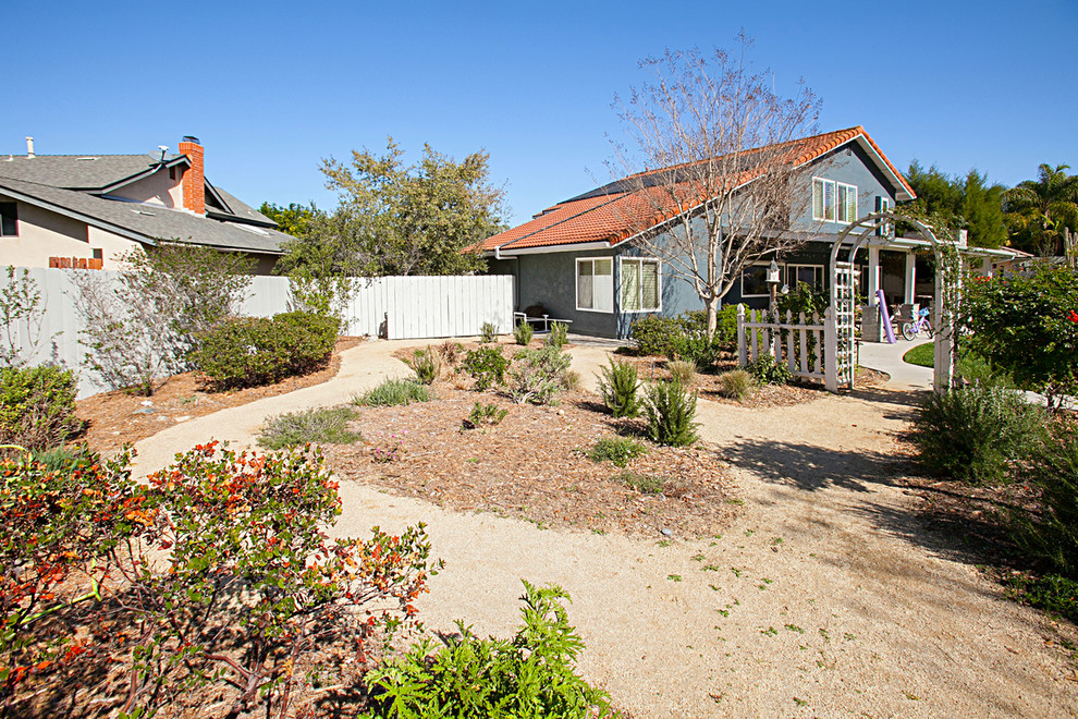 Photo of an expansive rustic back xeriscape full sun garden for summer in San Diego with a garden path and decking.