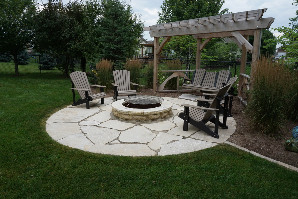 Inspiration for a medium sized traditional back formal full sun garden for summer in Other with a fire feature and natural stone paving.