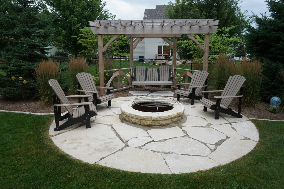 Idee per un patio o portico tradizionale di medie dimensioni e dietro casa con un focolare e pavimentazioni in pietra naturale