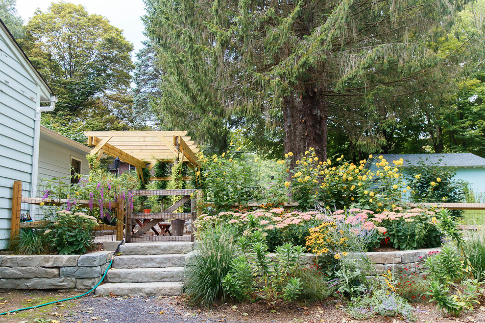 This is an example of a mid-sized rustic partial sun side yard concrete paver garden path in New York.