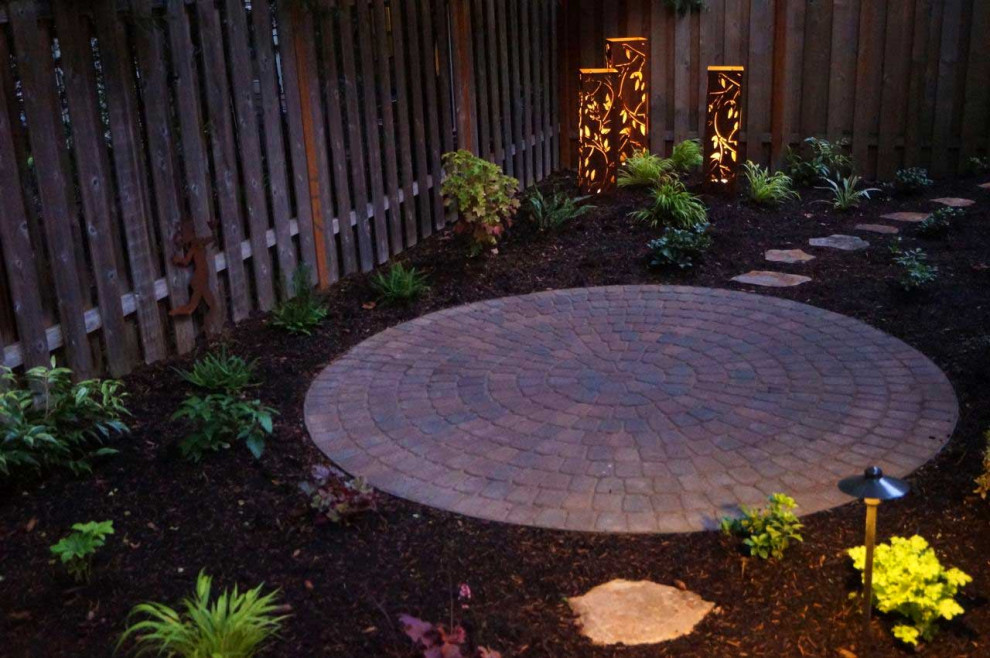 Photo of a small modern back partial sun garden in Portland with concrete paving.