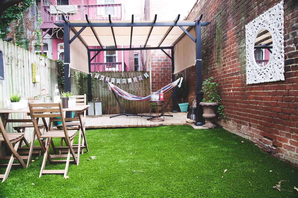 Photo of a small eclectic backyard landscaping in DC Metro with decking.