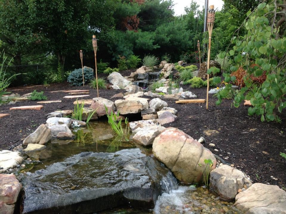 This is an example of a mid-sized traditional partial sun backyard mulch landscaping in Louisville.