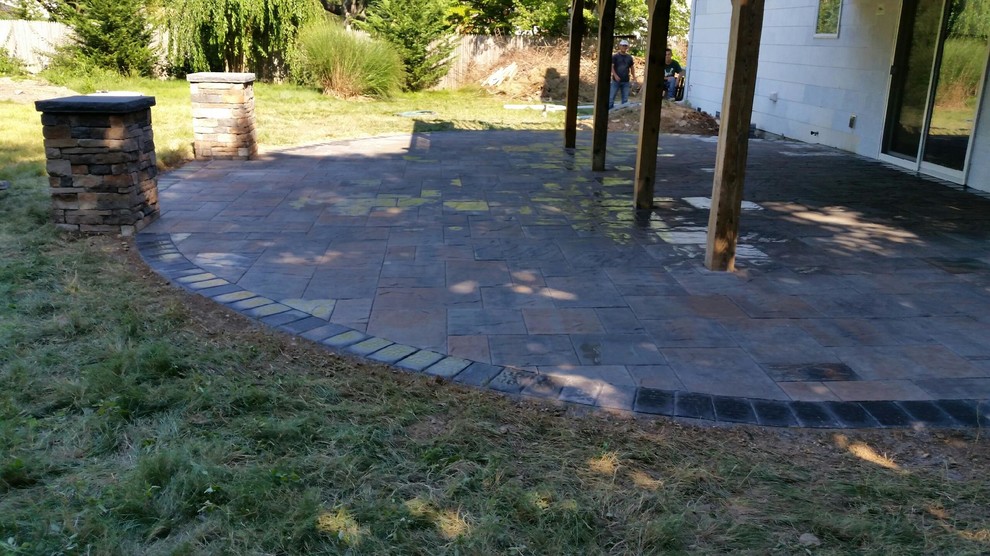 Medium sized traditional back partial sun garden in New York with natural stone paving.
