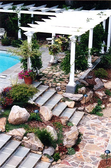 Classic back partial sun garden in New York with an outdoor sport court and natural stone paving.