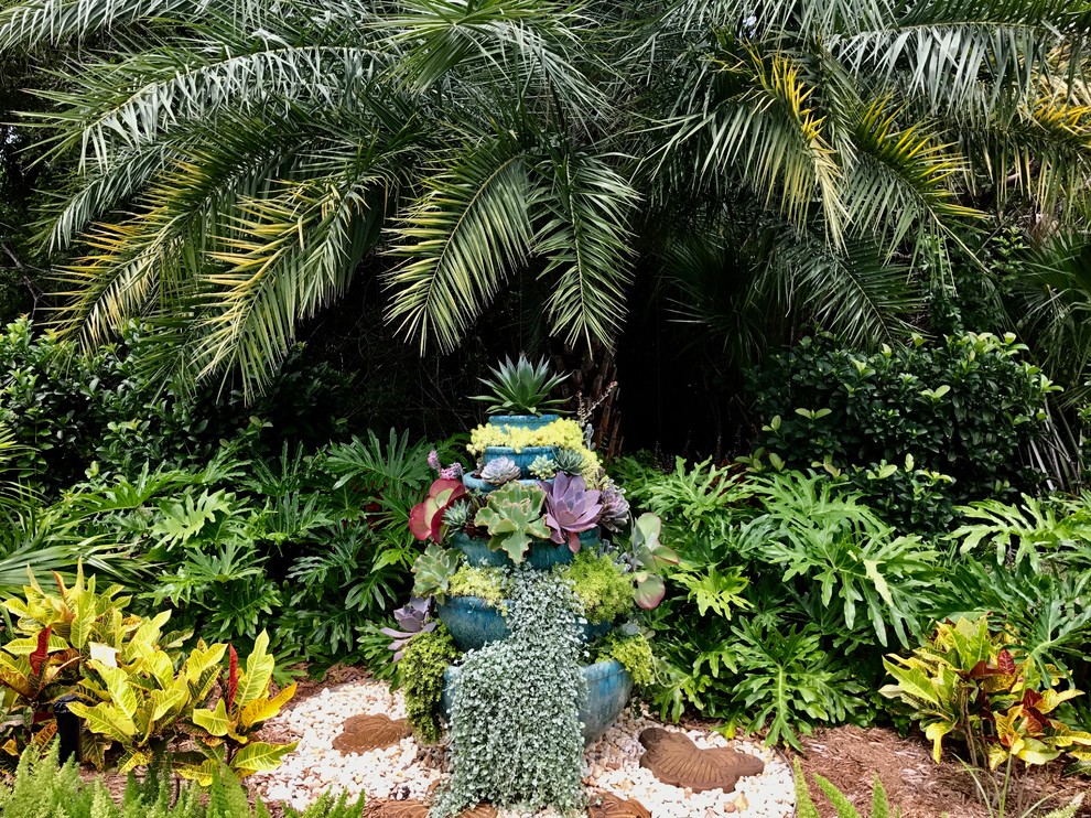 Inspiration for a large tropical partial sun backyard mulch formal garden in Orlando for summer.