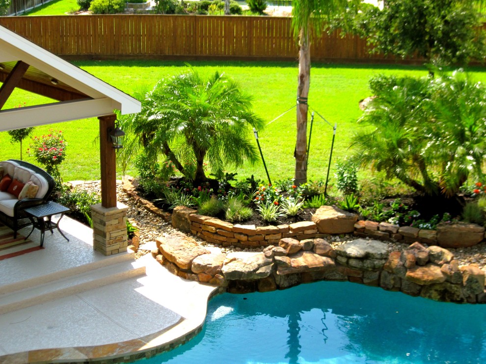 Photo of a tropical full sun backyard landscaping in Houston for summer.