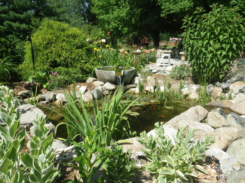 Idées déco pour un grand jardin arrière classique l'été avec un bassin, une exposition ensoleillée et un paillis.