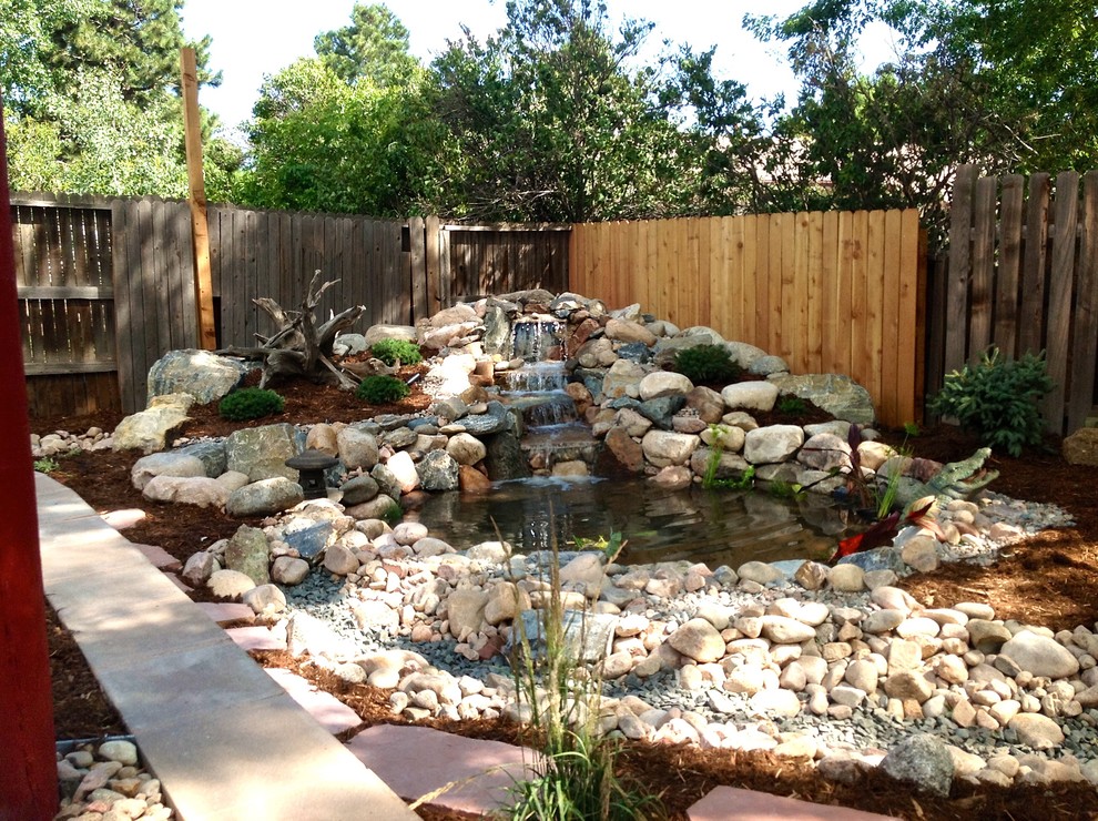 Photo of a mid-sized asian partial sun backyard brick landscaping in Denver for summer.