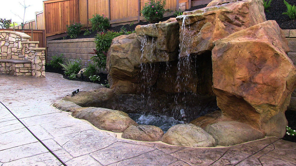 This is an example of a medium sized world-inspired garden in Manchester with a water feature.