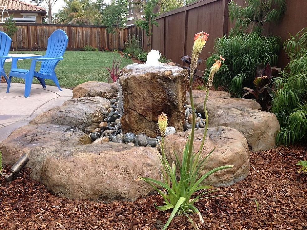 This is an example of a mid-sized tropical water fountain landscape in Manchester.