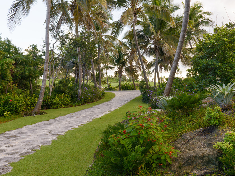World-inspired garden in Miami with natural stone paving.