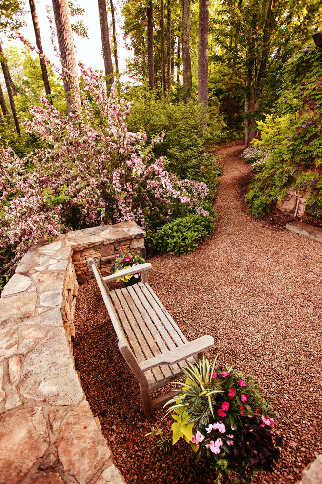 This is an example of a huge traditional partial sun side yard gravel formal garden in Charlotte for spring.