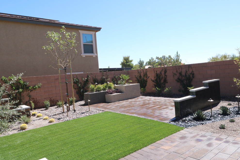 Inspiration for a small modern drought-tolerant and full sun backyard concrete paver landscaping in Las Vegas for summer.