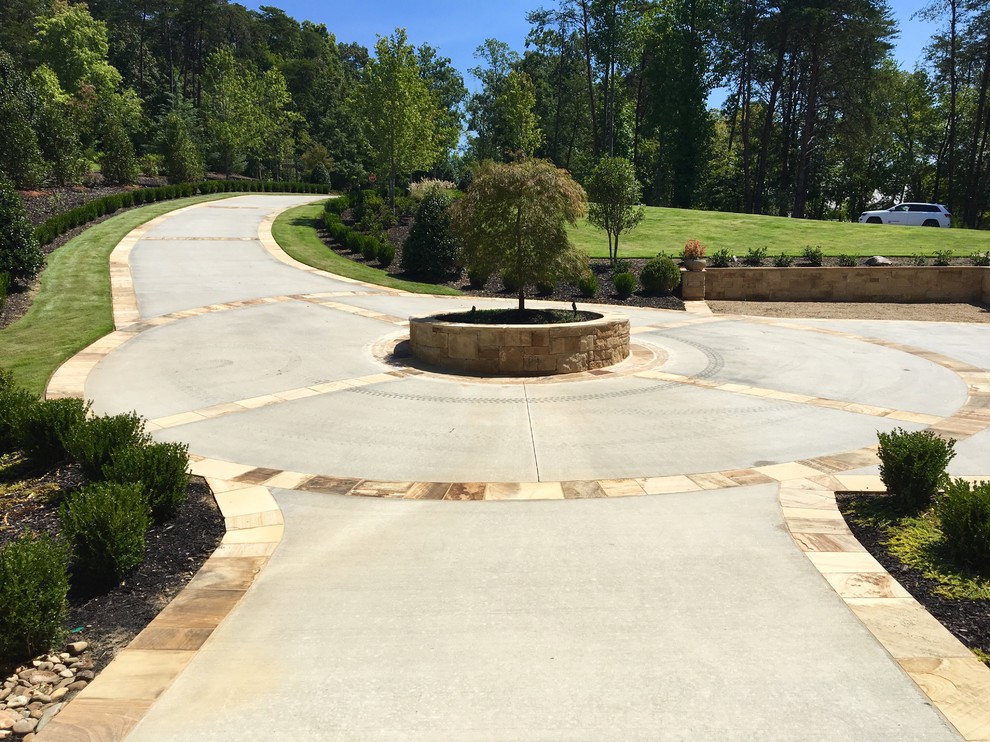 Photo of a large traditional partial sun front yard concrete paver driveway in Other.